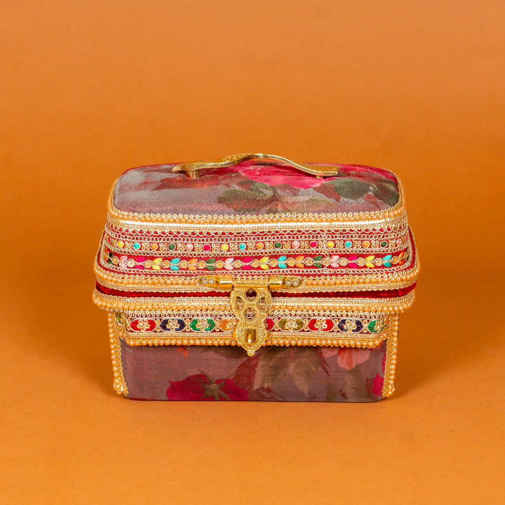 Surkh Makeup Vanity Box in deep maroon floral fabric with brass peacock handle