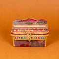Surkh Makeup Vanity Box in deep maroon floral fabric with brass peacock handle