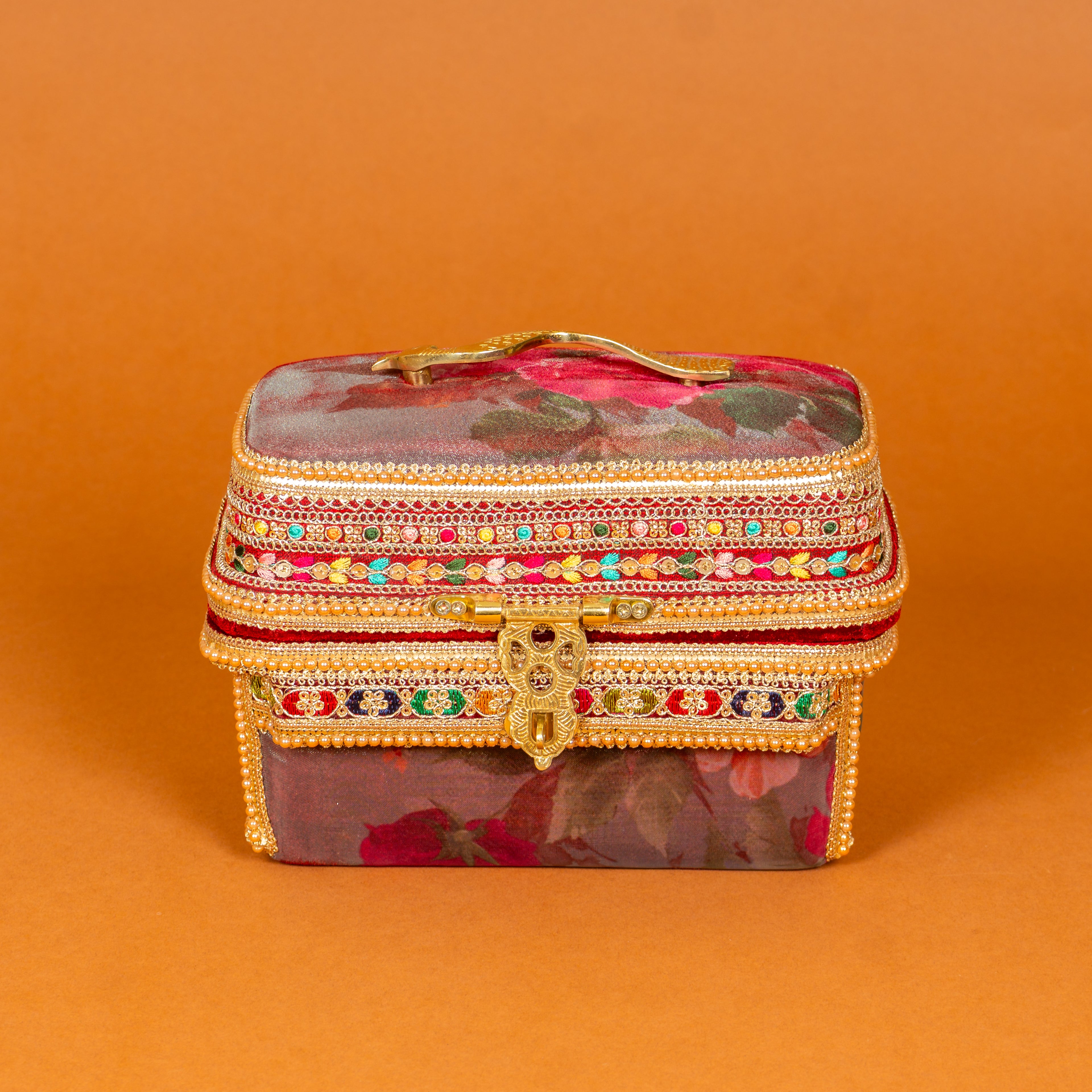 Surkh Makeup Vanity Box in deep maroon floral fabric with brass peacock handle