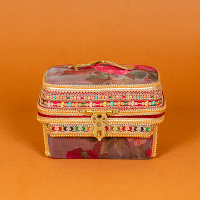 Surkh Makeup Vanity Box in deep maroon floral fabric with brass peacock handle