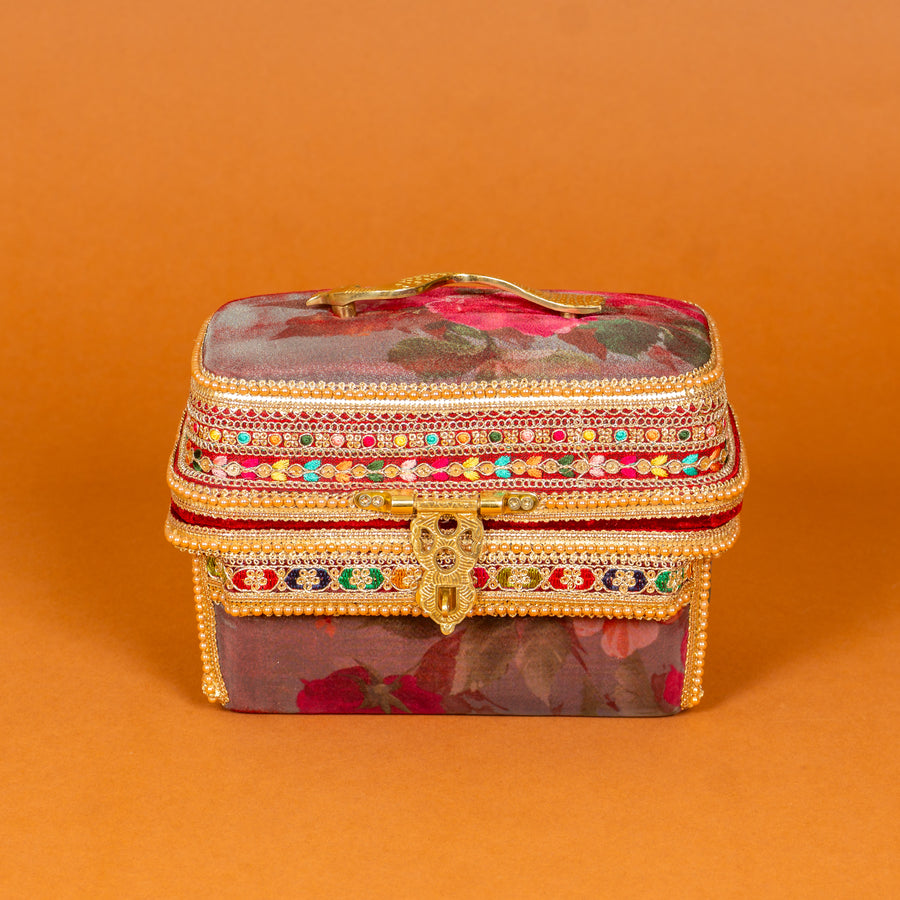 Surkh Makeup Vanity Box in deep maroon floral fabric with brass peacock handle