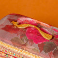 Surkh Vanity Box side view showcasing maroon fabric and regal peacock handle detail