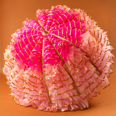 Pink and gold decorative item on an orange background